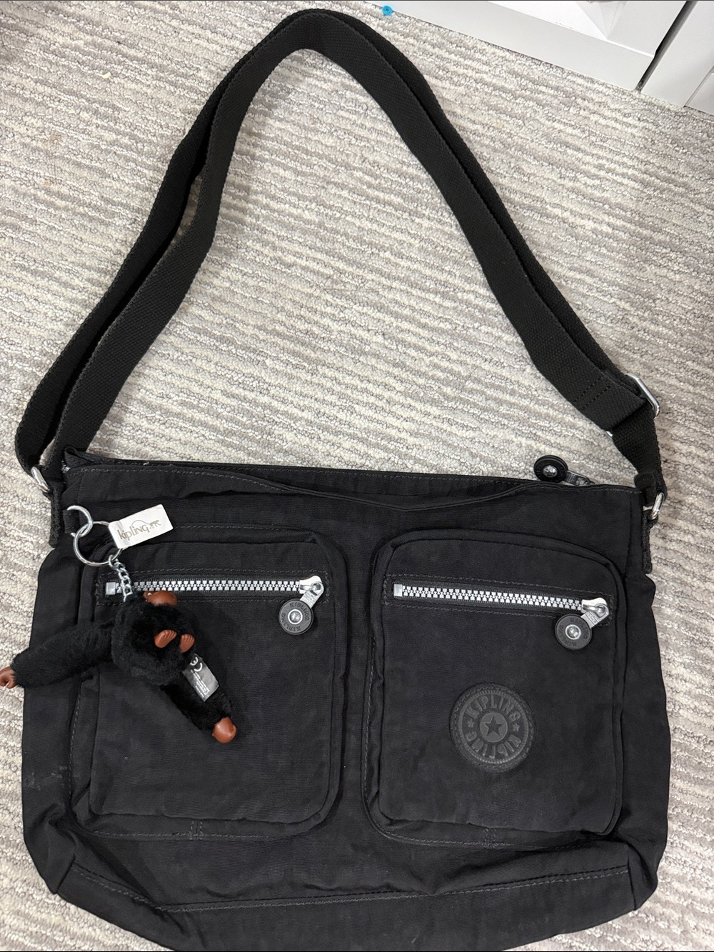 Kipling Black Crossbody Bag with Front Zip Pockets and Monkey Charm